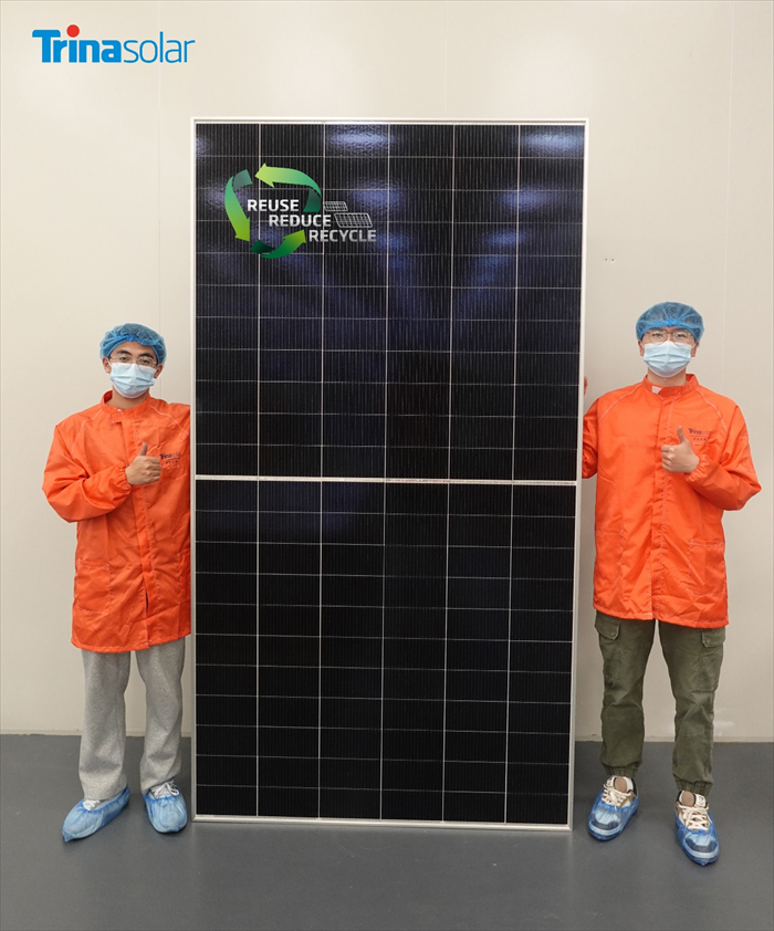 Two Trinasolar employees posing with the world's first fully recyclable solar module.